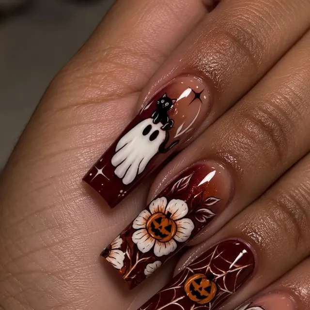 Hand-painted Halloween ghost and pumpkin nails